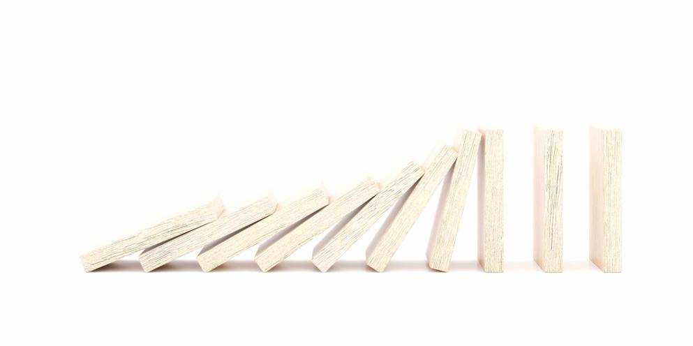 Wooden dominoes falling