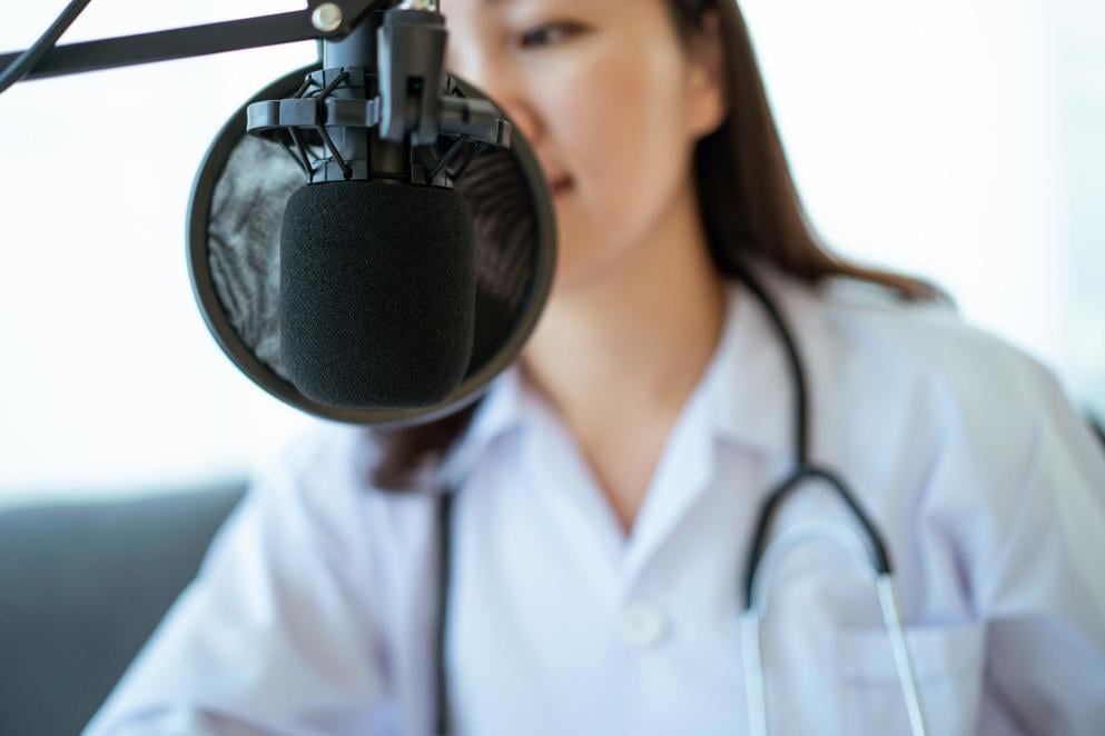 Doctor speaking into podcast mic
