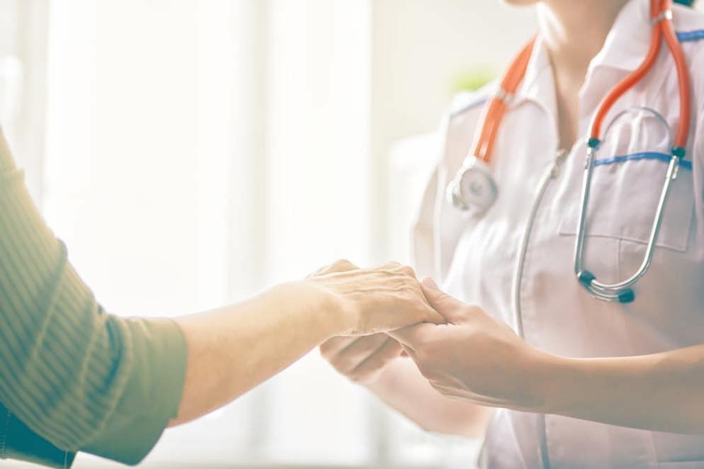 Doctor holding patients hand
