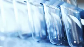 Blue test tubes arranged in a line, disappearing into the background